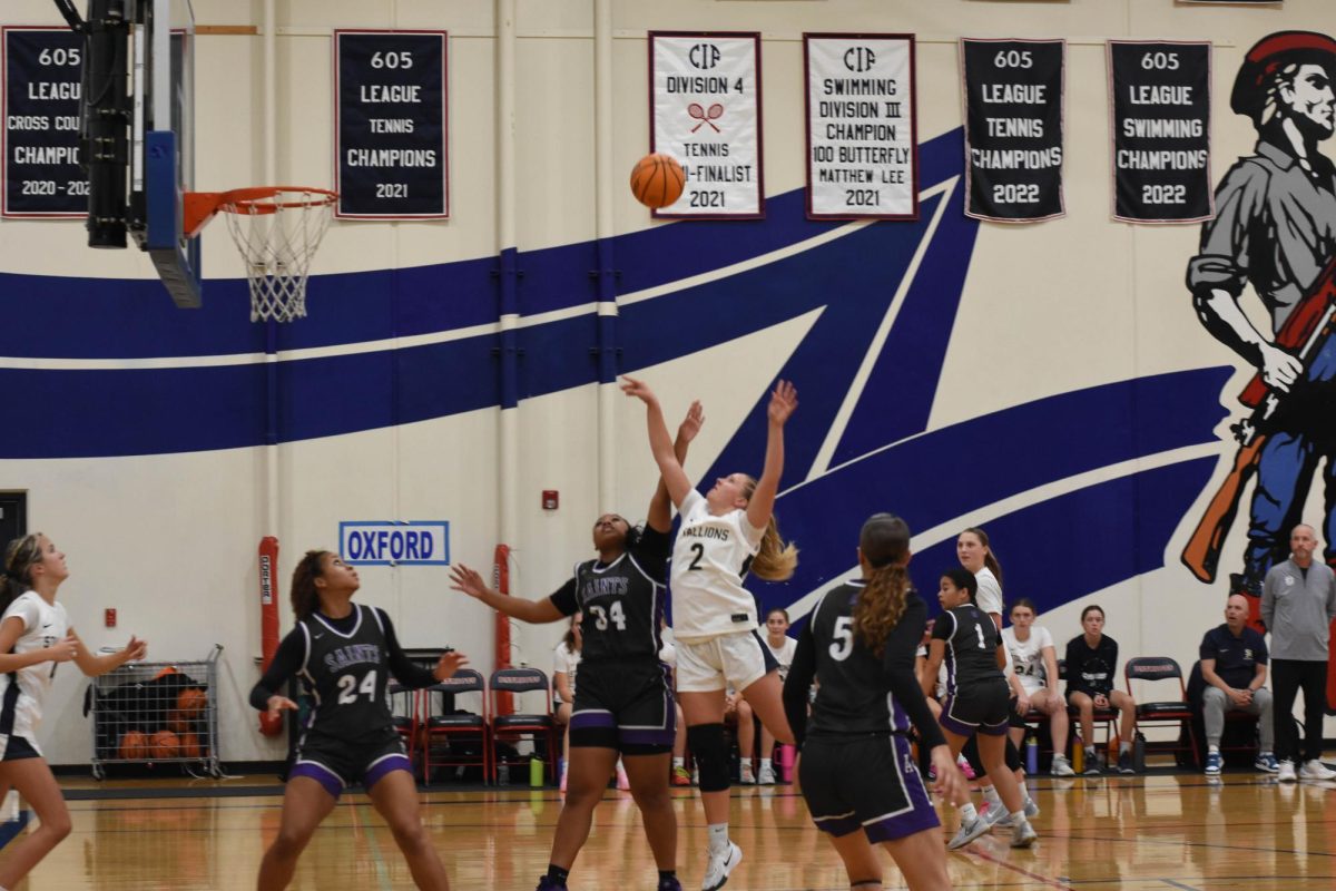 Ellasyn Hunter (11) leaps to shoot the ball over the Saints during the game against St. Anthony. After a ferocious battle, the Stallions ended the game with a score of 32-49, in favor of the Saints. 
