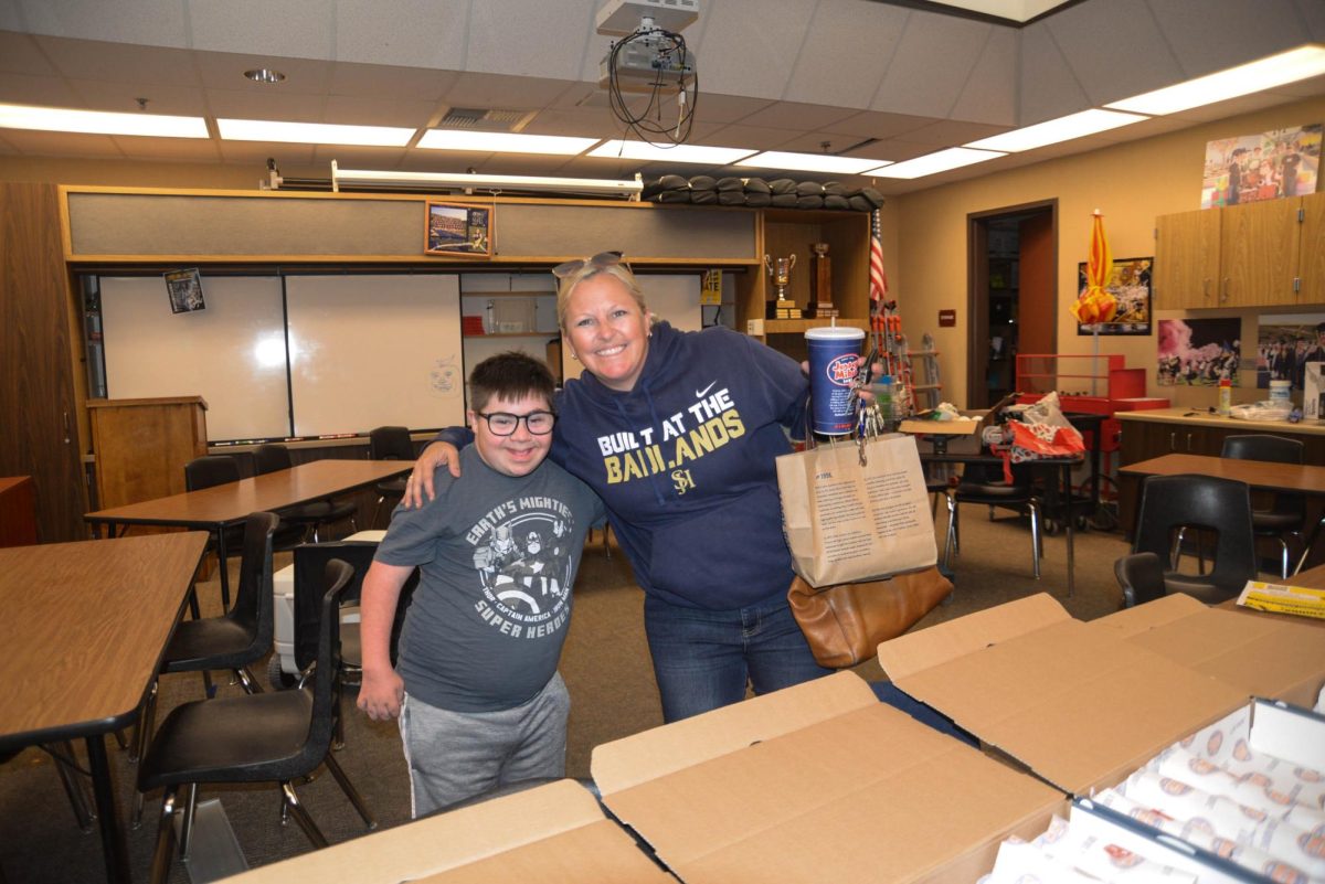 Smiling from ear to ear, school representative Paul Freeman and Activities Director Brooke Valderrama show off their RFTB spirit by handing out sandwiches to ASB students. 
