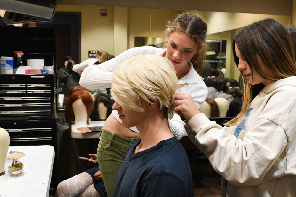 Brennan Crisp (11) and Maggie Zysman (9) work on hair and makeup for cast member William Kreutinger (11) for upcoming SJHHS theatre production show, Puffs. 
