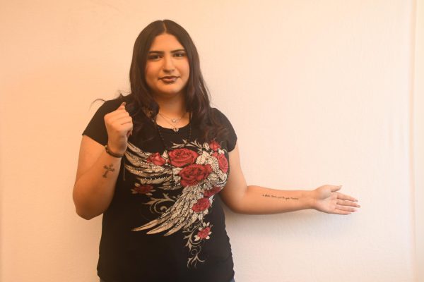 Adriana Mora (11) displays her tattoos which she got for her birthday. The tattoo on her right arm being a cross and the left arm is a script her grandma had wrote to commemorate her when she passed away.
