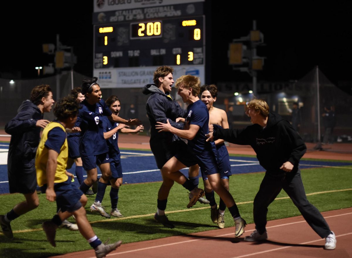 During the final two minutes of the boys varsity soccer game on January 10, Jake Tanner (12) scores giving his team the 1-0 win over the Capistrano Valley Cougars. As soon as Tanner scored, his teammates ran over to him to celebrate his goal and the team’s victory. 