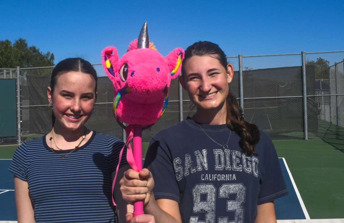 Natalie Barry (10) and Lily Zollinger (9) pose with the infamous pink horse. The stallion is used to "punish" JV members of the tennis program following a lost match.