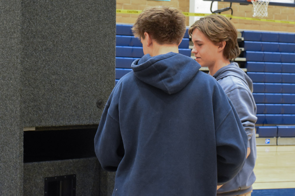 Parker Strongin (11) has his back turned doing adjustments to the speakers in the gym, with one of the ASB Commissioners of Tech, Shiloh Skelton (10). This is preparation for school events ASB handles such as pep rallies, and in this case the CAASPP assembly for Juniors.