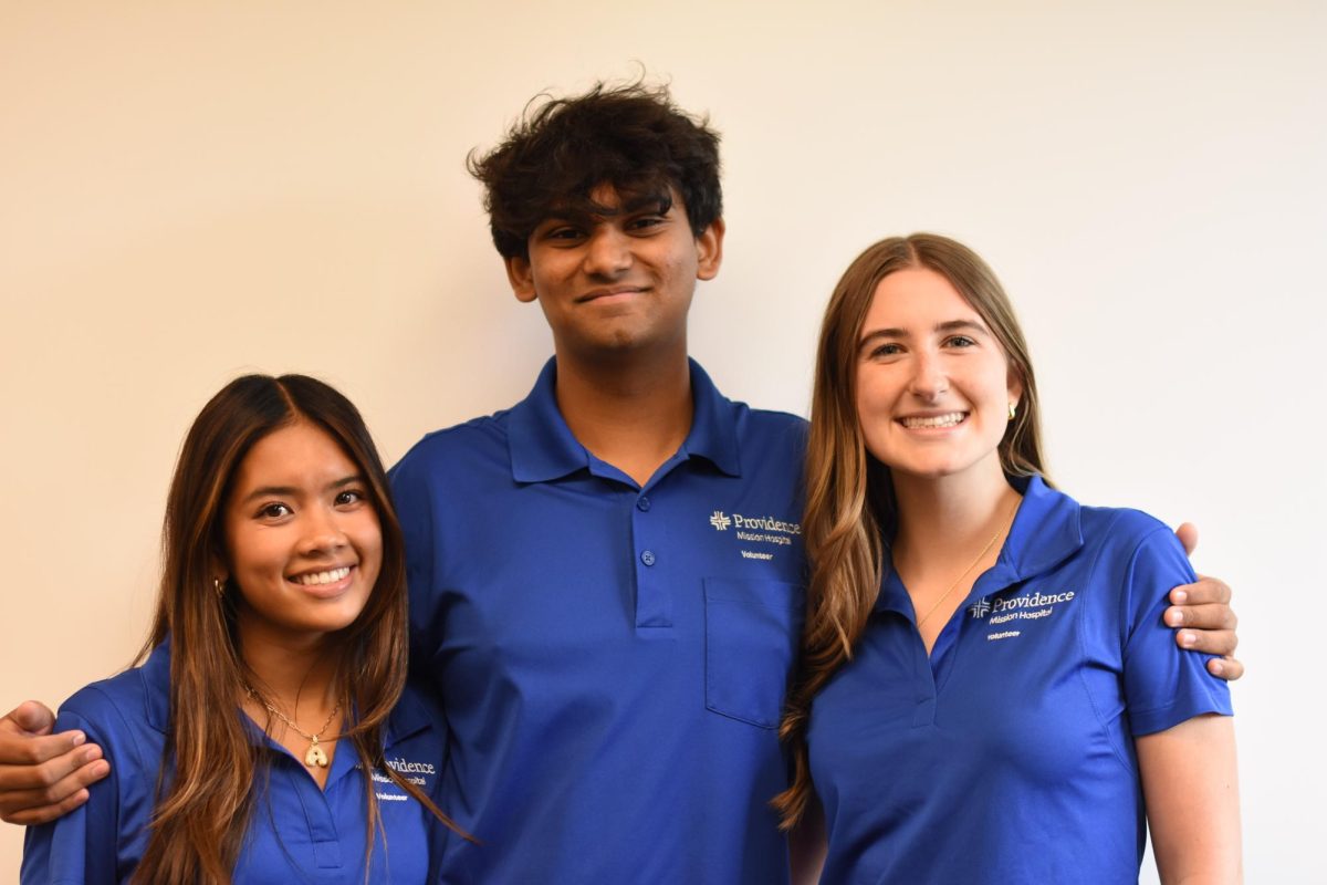 Aspiring health care workers Sadie Parsons (11), Sid Gaikwad (11), and Ava De Ramos (11) all participate within the Mission Hospital Volunteer program. The program offers different volunteer work within the different departments of the hospital.