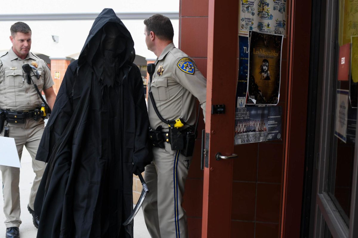 After the heartbeat played on the loudspeaker flat lines, the Grim Reaper and officers enter Alvaro Serrano’s classroom to take one student who “died.” Once the student is pulled out, the officers read the student's obituary and place it on a black cloth draped over the students seat. The student is sequestered and isn’t be seen or heard from by anyone until the assembly the following day.