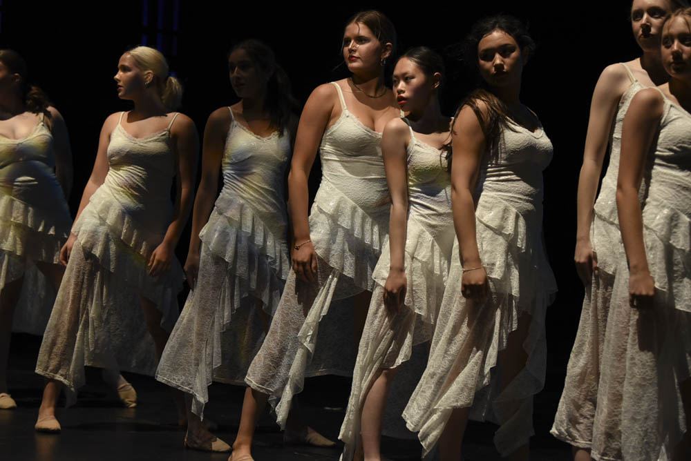 This elegant dance is performed in long lace dresses which adds a dramatic flare to the already spiritual dance. Siena Wells (10), Queanna Nguyen (11), and Audrey Chi (10) stand in their finishing poses as they look out into the audience. 