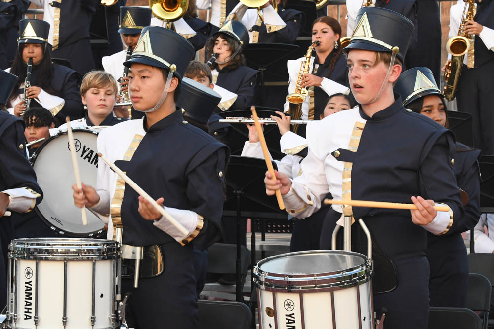 To celebrate the Stallions scoring a point, the band proudly plays their instruments. Students, Spencer Waldren and Colin Lau bang on their drums as the crowd erupts in praise for their home team. 