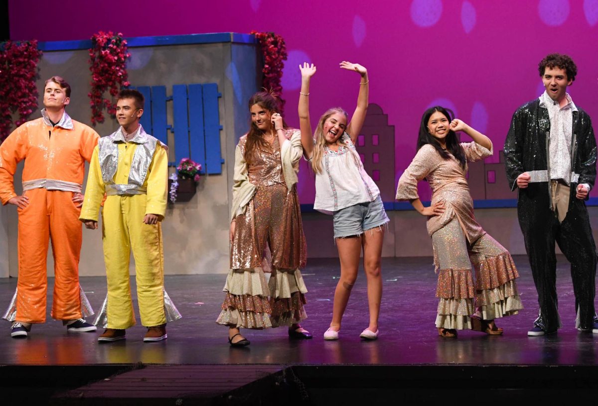 In the final bows of their two hour musical, the main soloists including Jackson Thurman (12), Nash Tanner (10), Kate Martin (11), Tali Doyle (10), Mady Macabale (11), and Taylor Padilla (12) gather to pose for the crowd's applause. They take in the moment of all their hard work, and the small community they built within the show.