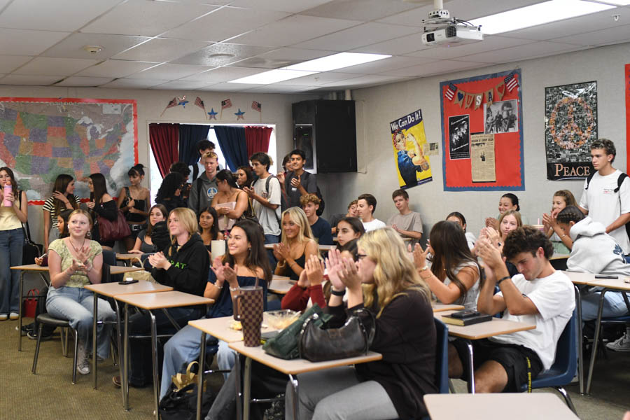 Students applaud as Trustee Davis speaks out about freedom in the overflowing classroom filled with members of Turning Point USA. In memory of the late founder, Charlie Kirk, students strive to preserve and continue his message.
