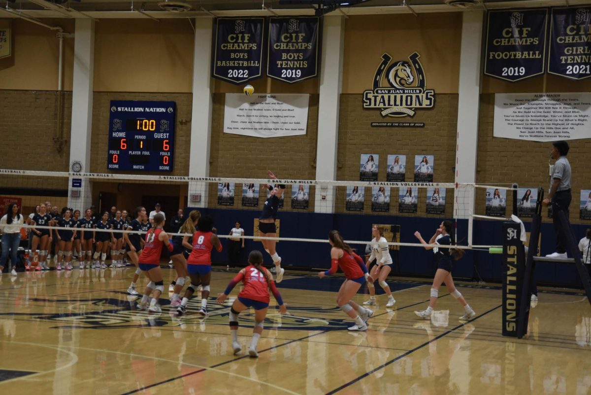 Megan Hodges (11) leaps into the air to strike the ball into Los Al's court. To gain a lead on Los Al.