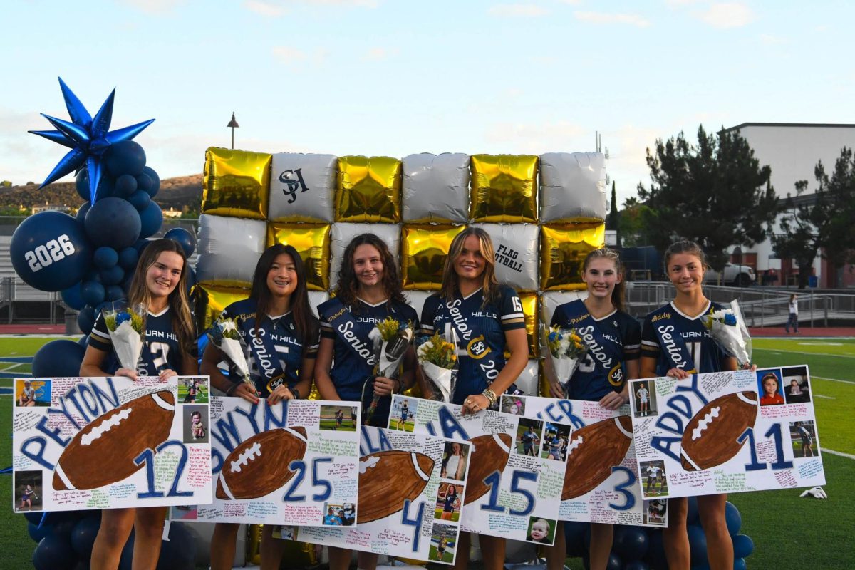 The Girls Flag Football seniors group together with posters signed with sentimental messages from their underclass teammates. They were given sashes embroidered with their names and bouquets of flowers to celebrate all of their achievements as they send them off.
