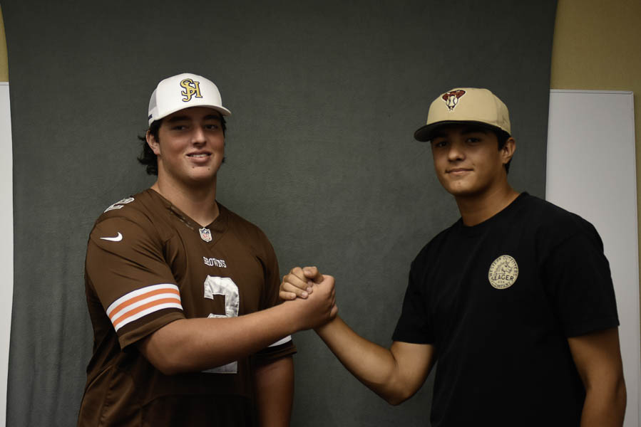 Cooper Javorsky (12) and Garrett Gondolfo (12) express their bonding upon success of recruitment. Gondolfo is going on to pitch at High Point University baseball while Javorsky has collected 17 offers for his position as an offensive linemen. 