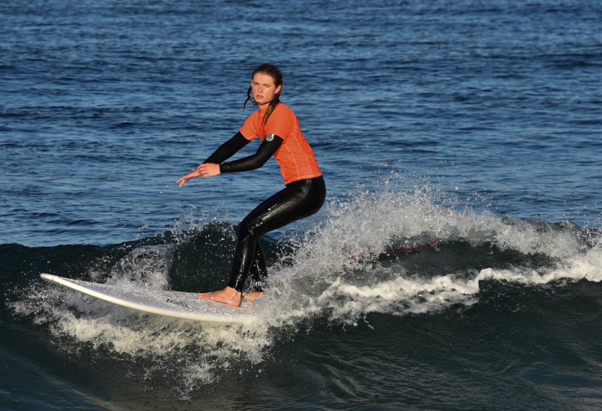 Lily Shay (12) brings the heat to the SJHHS surf meet, competing against Capo Valley High School in the girls’ longboard division. She maneuvered through the waves with determination and skill.