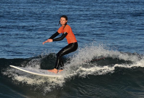 Lily Shay (12) brings the heat to the SJHHS surf meet, competing against Capo Valley High School in the girls’ longboard division. She maneuvered through the waves with determination and skill.
