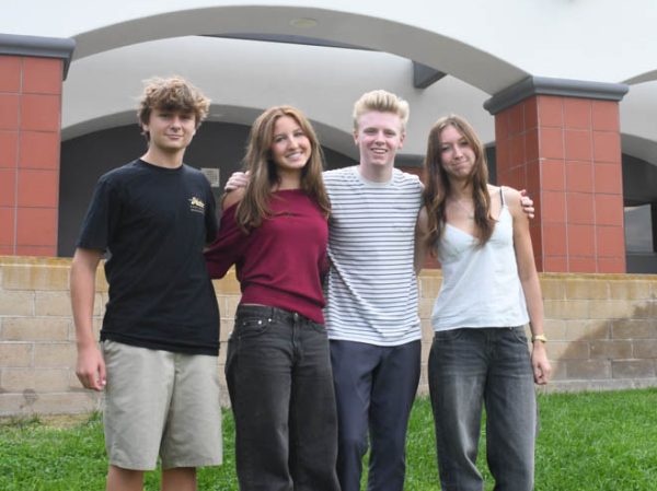 Rhys Brandon, Braylin Perry, Brigham Bourne, and Cambria Campbell (10) stand together on the field next to the stairs leading to the quads. All on the Just Serve council, the members will soon prepare to host their first meeting of the school year.