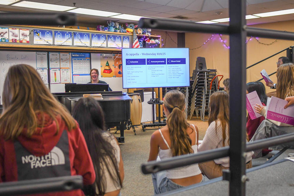 On the piano, Erin Theodorakis leads the Acapella program in the choir room. Assisting choir director Michael Ushino, she helps prepare students for their upcoming concert. 