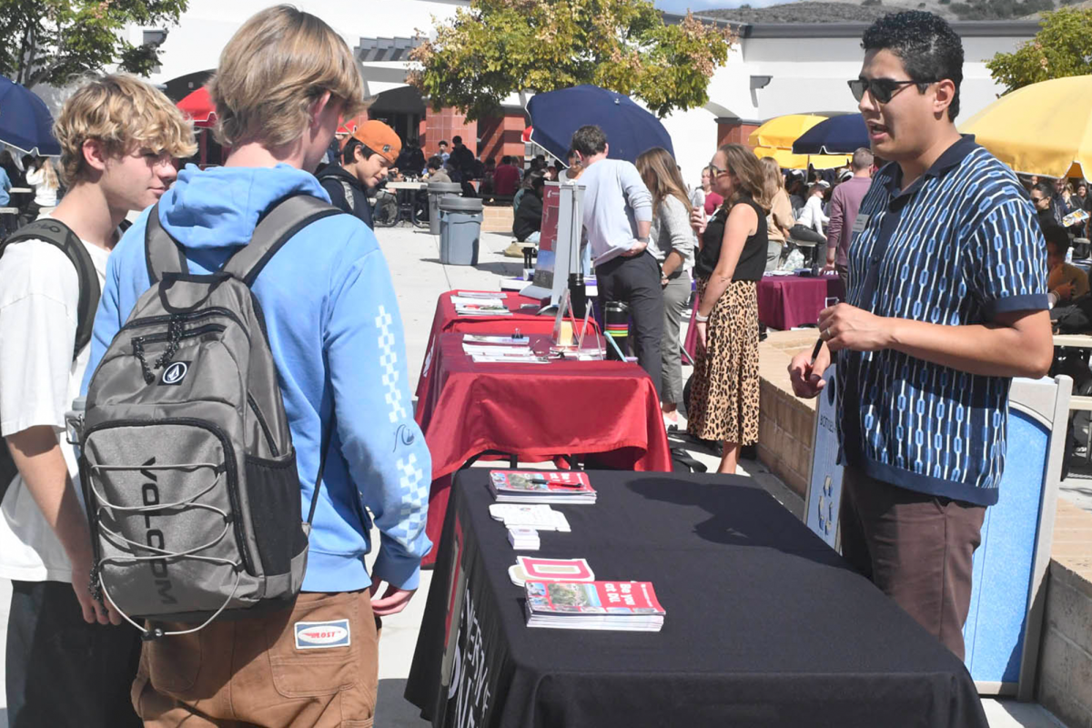 Students learn about benefits of different colleges in the United States during the College Fair held at lunch in the Upper Quad in order to more accurately understand which colleges they want to apply too alongside financial aid options
