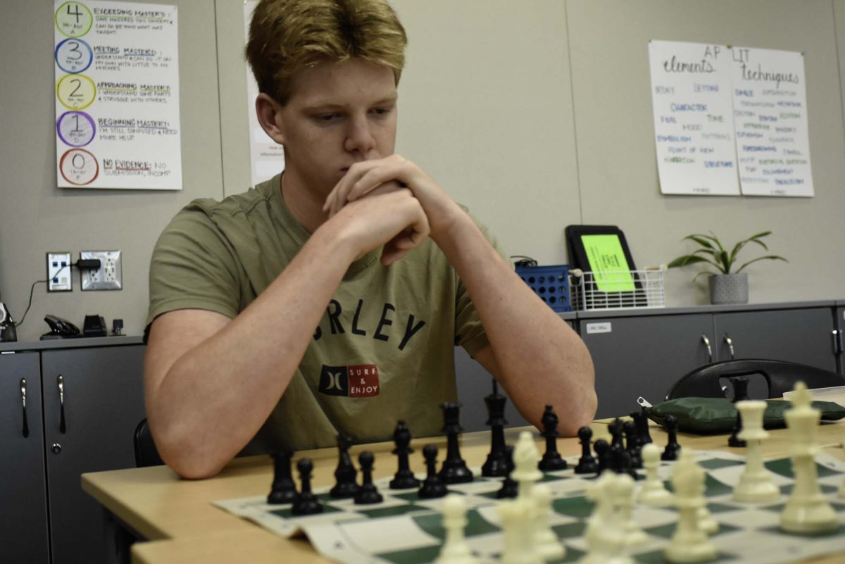 Craig Lienen (12) holds his composure as he continues to decide his next move while under the clock. The Chess club has been holding a tournament with the first match being finished, the second match happening after winter break. 