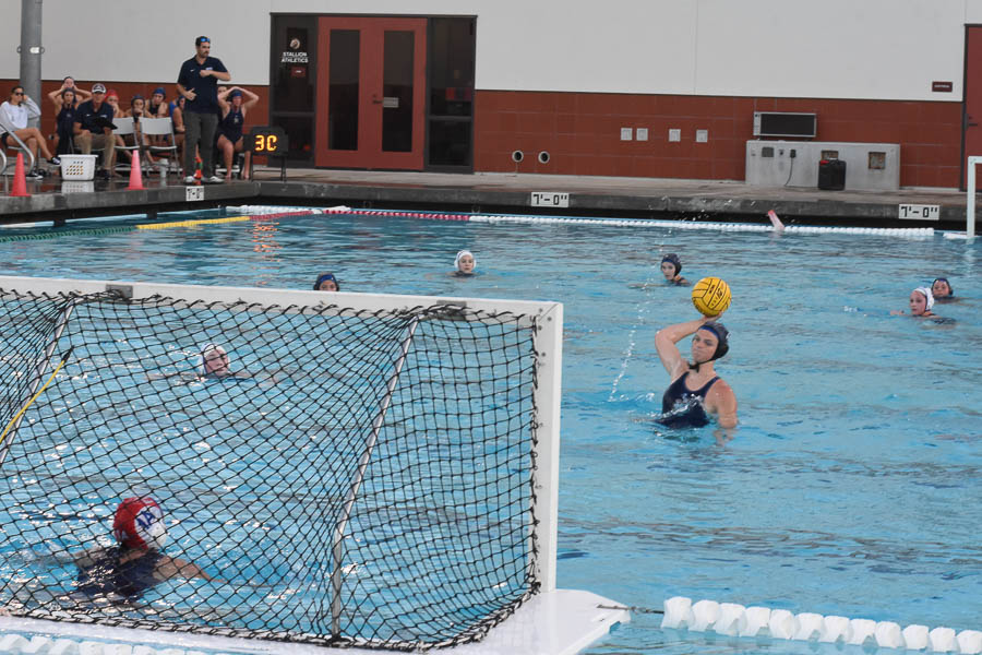 Eliza Walburger (12), prepares to score on the Dana Hills water polo team. She makes it past the goalie shortly after and claims a point for the Stallion team.