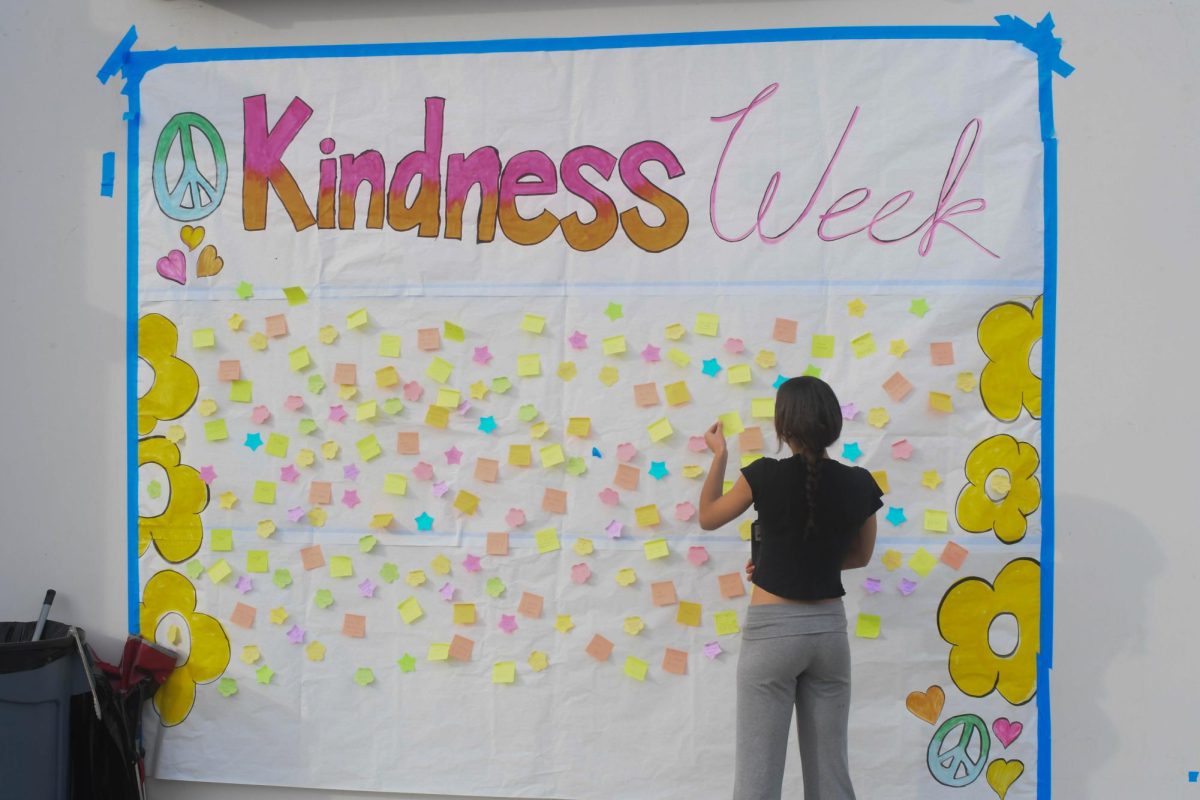 Saphira Millers (10) takes a sticky note from the Kindness Week poster in the upper quad. Kindness Week allows us to celebrate inclusivity, appreciate each other and be inclusive to all.
