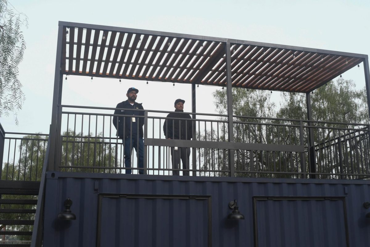 Staff members observe the baseball field from the newly completed concession stand. This new stand will expand the community aspect of the games hosted at San Juan Hills by adding new viewing experiences.