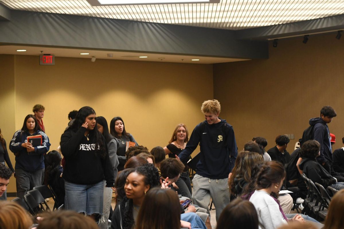 Sophomore English classes get ready for a presentation on High School readiness and being prepared for the future. Students settled into their seats while the presenter preps the slideshow and checks the sound system.