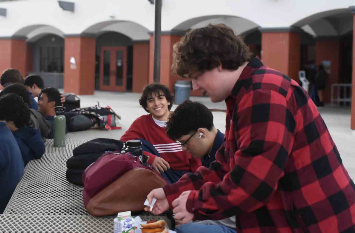 Downstairs in the lower quad during lunch is where friends come together and maintain the good vibes held down there. With Abraham Ramos (12) smiling toward the camera, Anthony Avalos (12) vibing to his music, and Braden LaClair (12) putting ketchup on his chicken sandwich.
