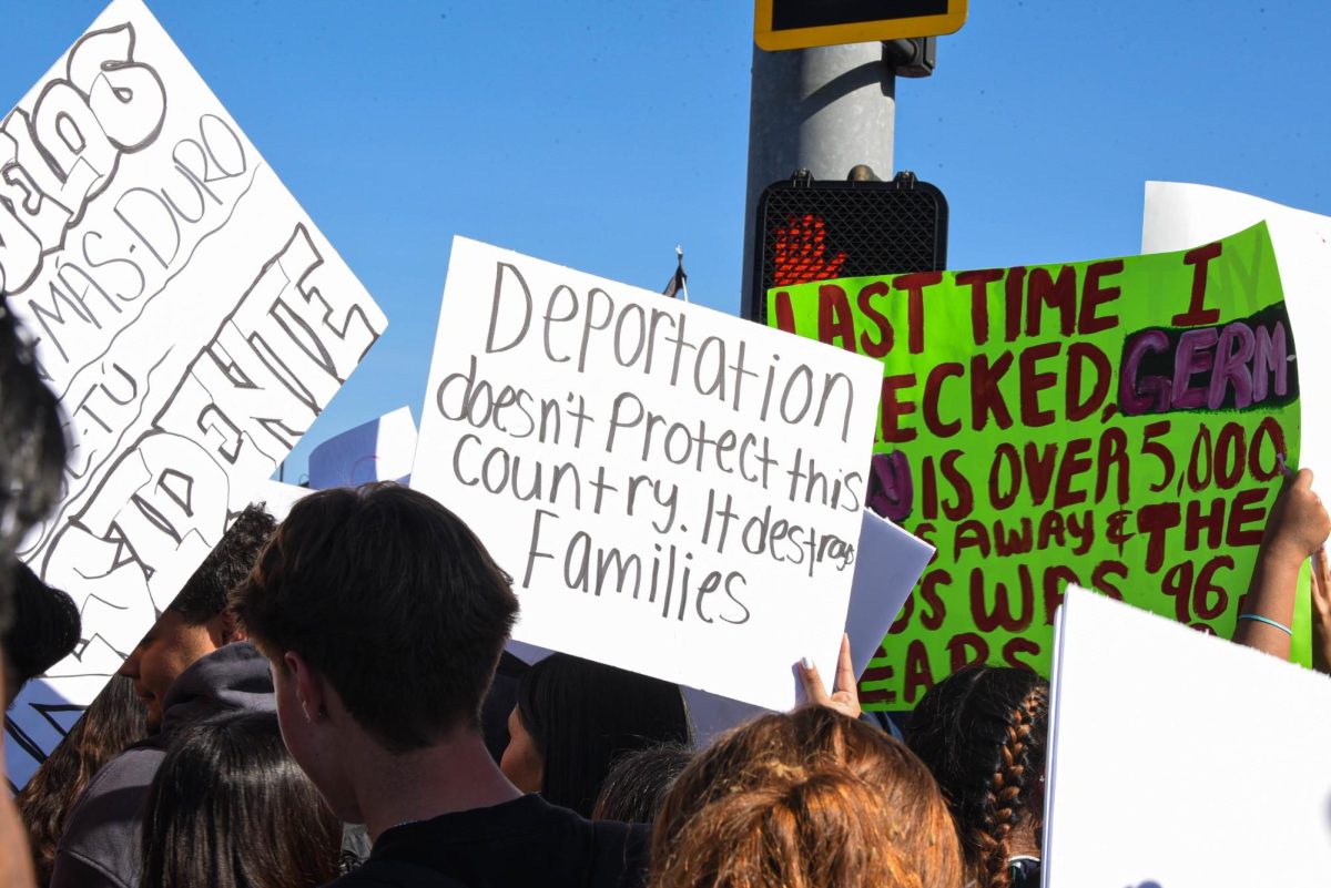 Stallions decorate signs and wave flags as they walk through San Juan. Students gather together and walk out of school in protest against ICE. 