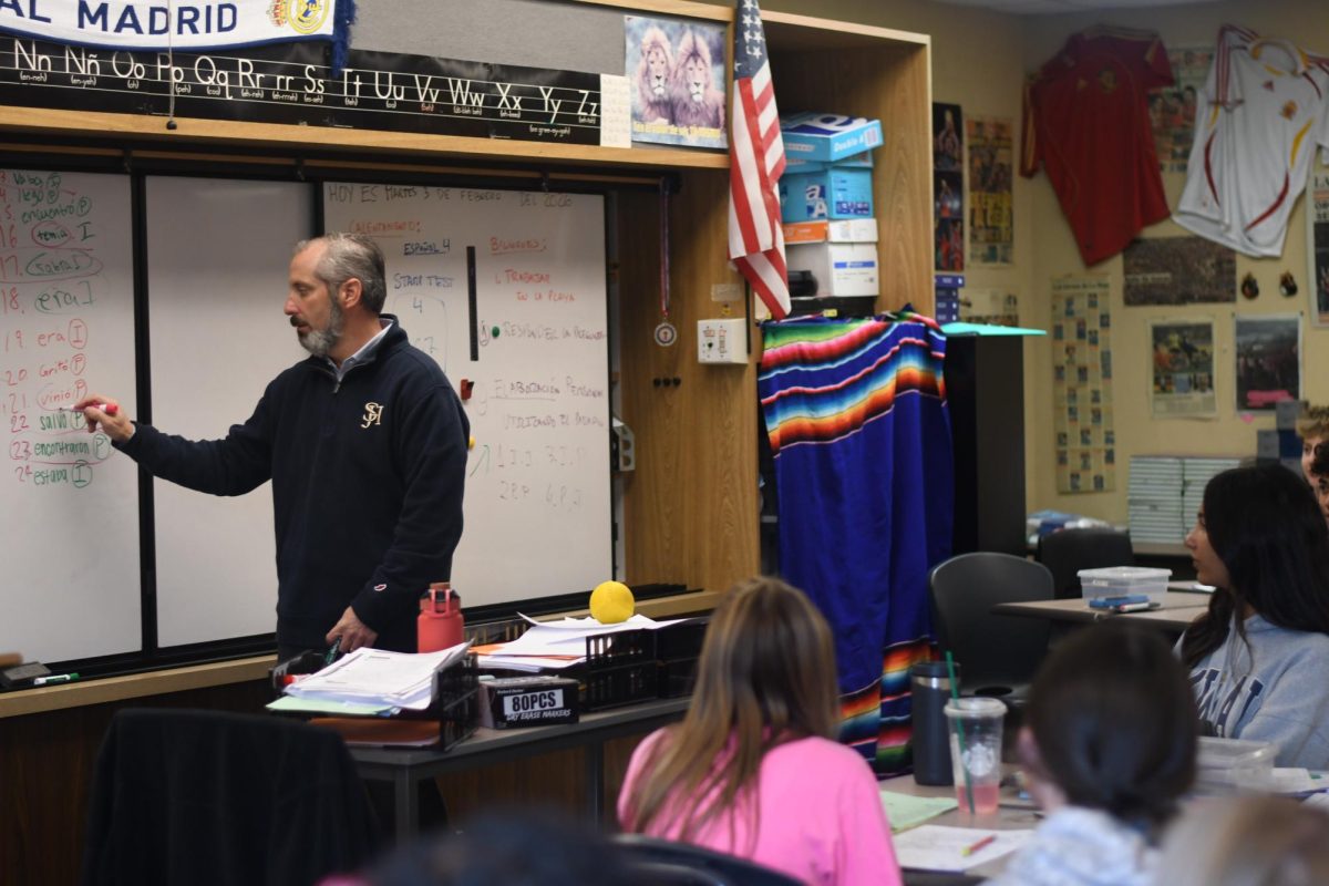  During his first period, Mr Serrano teaches Spanish 2, and carefully explains preterite vs. imperfect conjugations to the students. Paying close attention to assigned vocabulary, he shows the students how to identify which of the versions is in proper or not. 