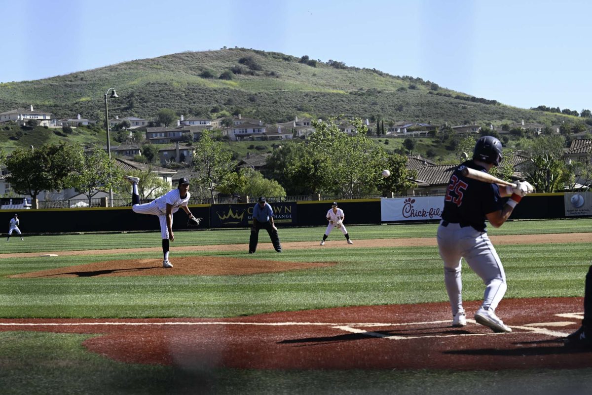 Pitcher Bronson Fizet (11) delivers his pitch towards the batter, leading them onto a strike out and switching positions with them for the top of the inning against Yorba Linda.