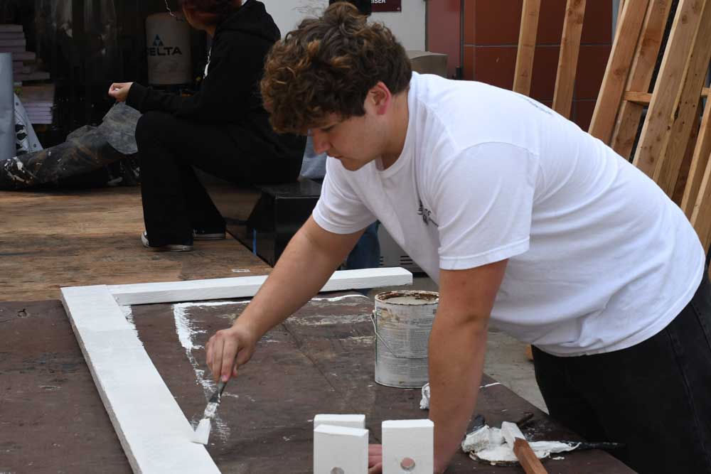 In MacDonald’s BITA 1 class, Milan Jovanovic (11) is painting a fence. He is focused on completing a second coat and perfecting his paint job. BITA is a building class that stands for Building Industry Technology Academy. 
