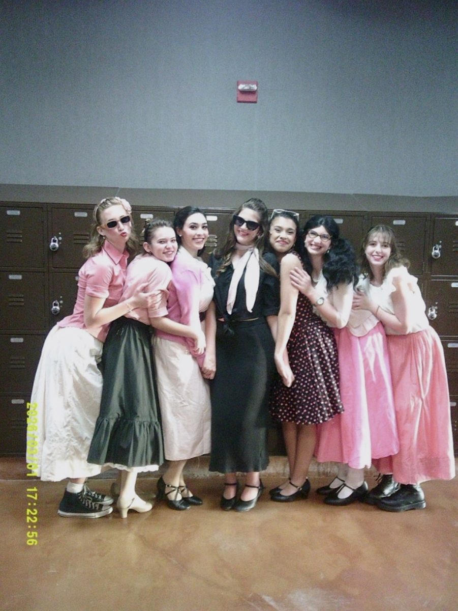 The cast for the musical poses together in front of the lockers. With only 24 hours to produce and perform a musical, the theater program rushes to get everything done.