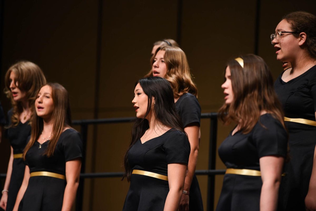 Audrey Chi (11) sings with the Acapella group as the audience listens intently. Choir often either performs in groups or solos, however the group performances feature more harmonizing.