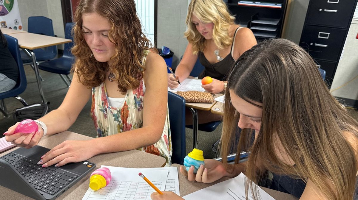 Students Reese Whitehead (11), Zoey Hallett (10), and Charlotte Facer (9), study in their class while fidgeting with various NeeDohs and other fidgets to improve their focus.