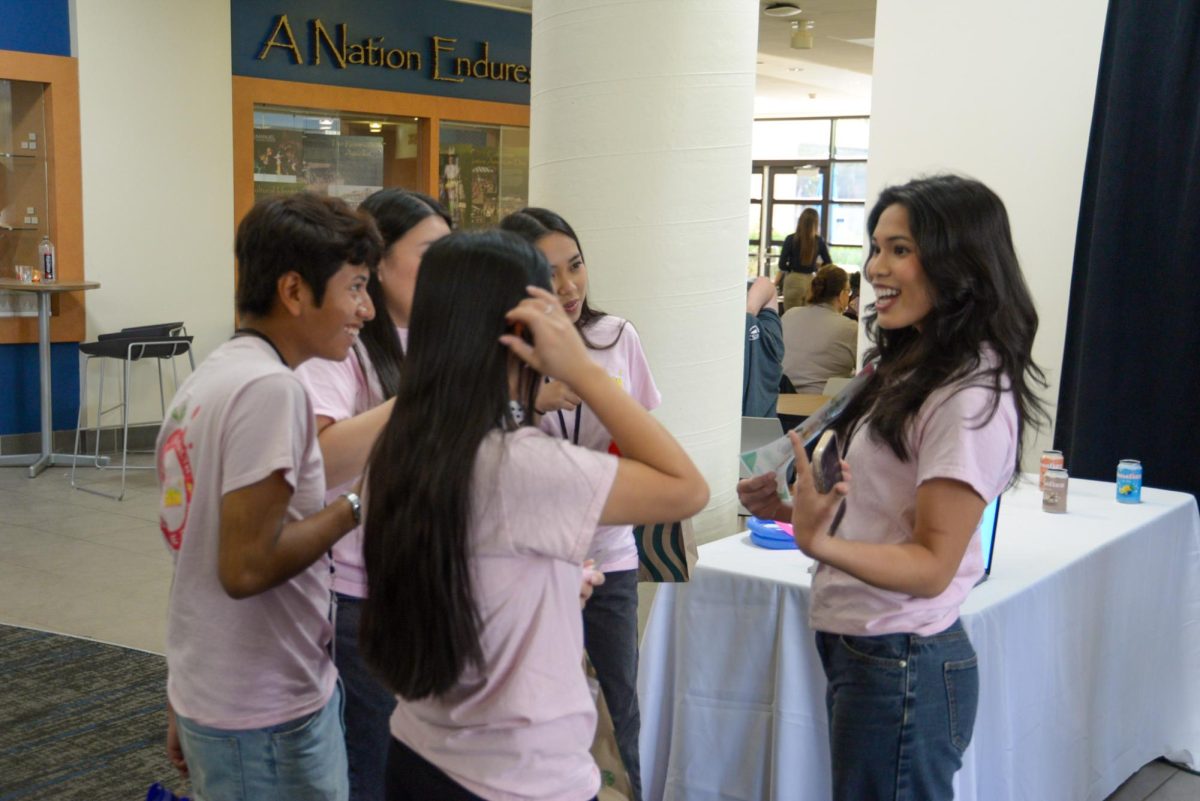 Ella Verde sells "Benefizz" soda during San Bernardino Virtual Enterprise trade show. In the Virtual Enterprise program, students attend trade shows where they compete against other high schools in categories like Sales, Marketing, Finance, and more. 