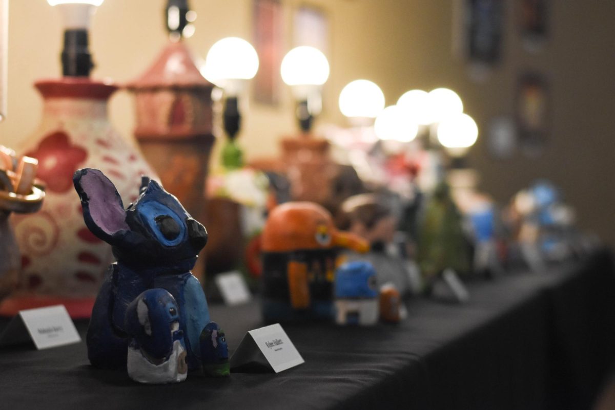 A close-up of hand-built nesting dolls highlights precision, with each piece showcasing the individual student's personality. At the front, a playful Lilo & Stitch inspired design stands out, showing how students blended traditional forms with their own creative ideas to make something unique.