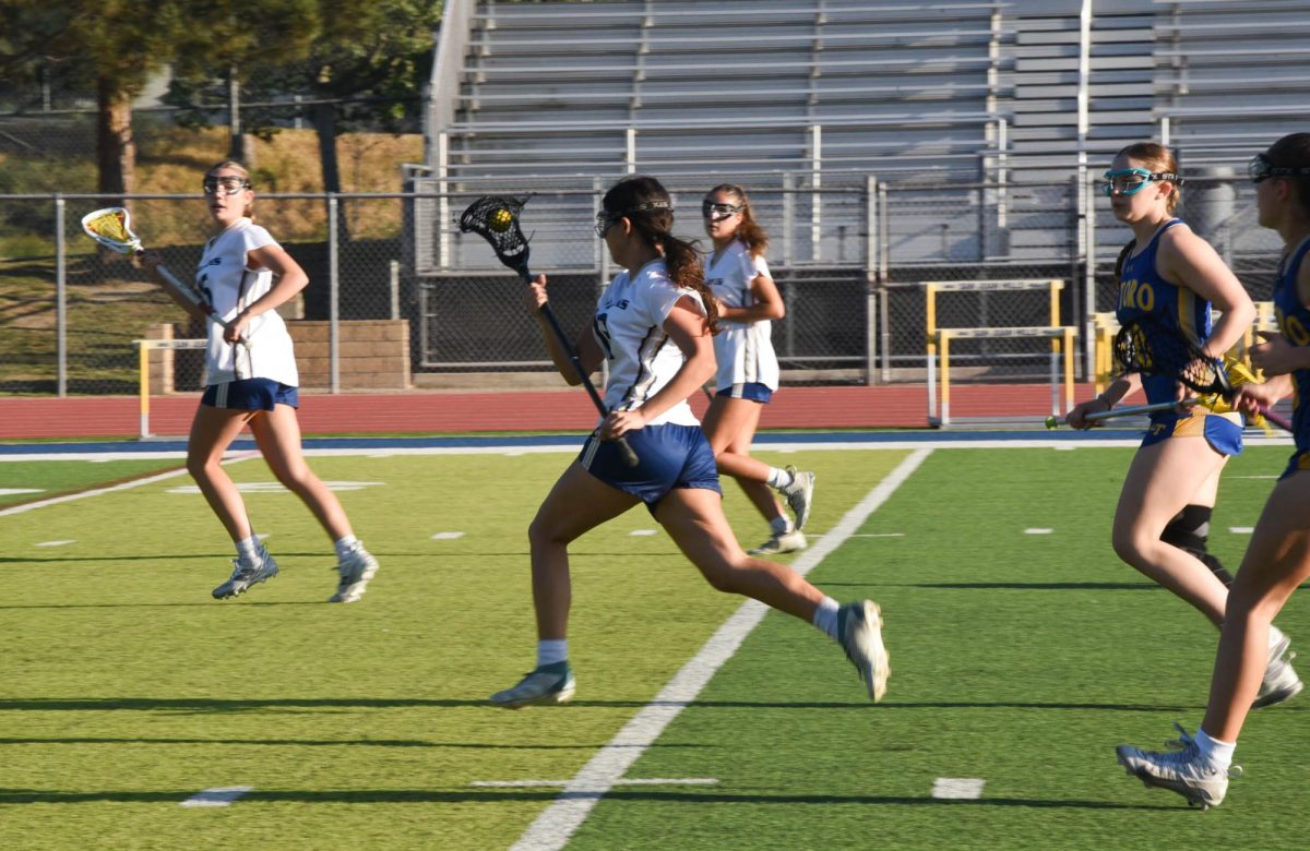 After a turnover, Teagan Acevedo (12) hurriedly makes a breakaway by running the ball from defense to offense in order to clear the ball and make a potential goal scoring opportunity. The Stallions are currently first in league by being 4-0 and 10-5 overall.