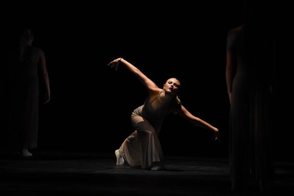 Ellie Johnson (11) lowers herself as the emotional music fills the theater. There were a variety of genres displayed in this dance show, making it truly unique compared to others in the past. 