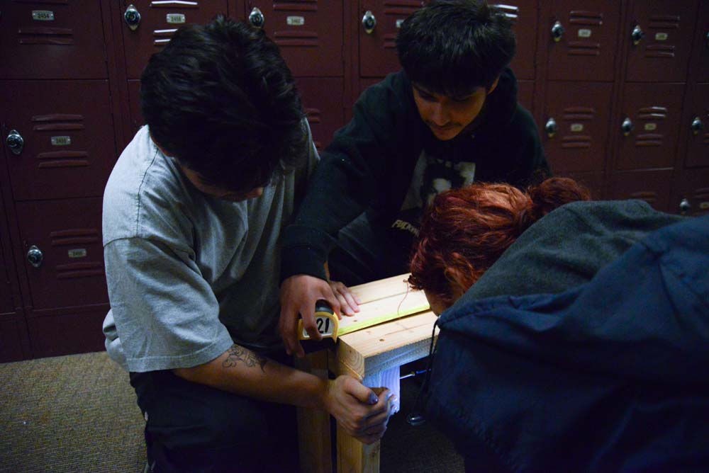 As Samantha Jamie (12) drills in a nail, Jonathan Barroso (12) stabilizes the wood, and Hector Lopez (12) measures it. All having a part in ensuring the wood is standing and stable during their first period in BITA. 