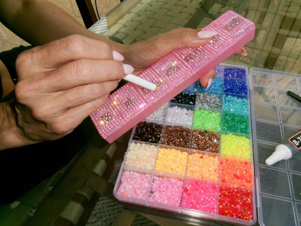  Once a trend associated with the early 2000s, bedazzling has slowly reemerged as both a fashion statement and creative outlet for the teens of today. From phone cases to pill boxes, people are finding ways to make ordinary objects feel more personal, playful, and expressive through tiny details and individual designs.