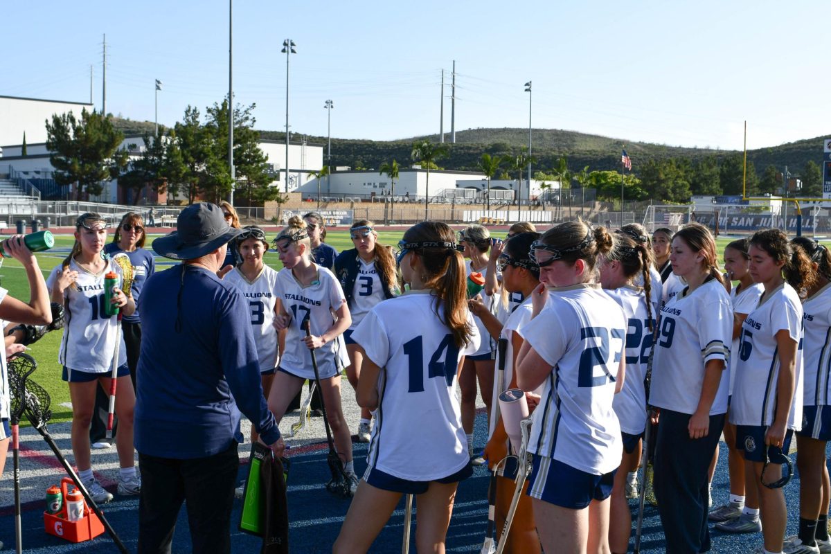 The girls lacrosse team huddles up during halftime during their Divison 2, Round 2 CIF game against the Royal High Islanders. After an undefeated league season, the Stallions ended up taking the loss with a score of 7-9. 