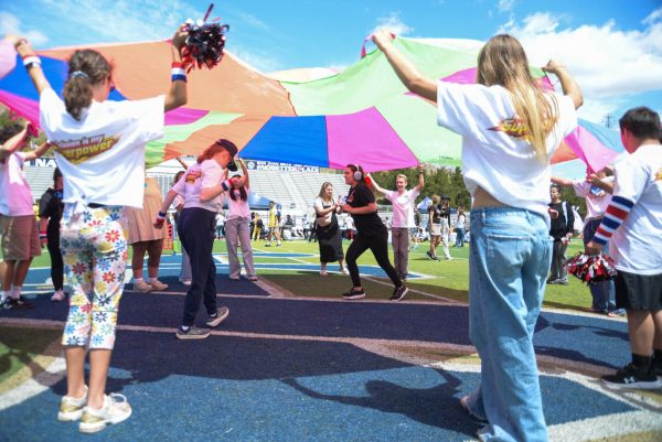 In the center of the field, students lift up the parachute for each other to run underneath. The bright colors combined with the smiles on their faces beautifully capture the joy that the Stallion Olympics strives to foster. 
